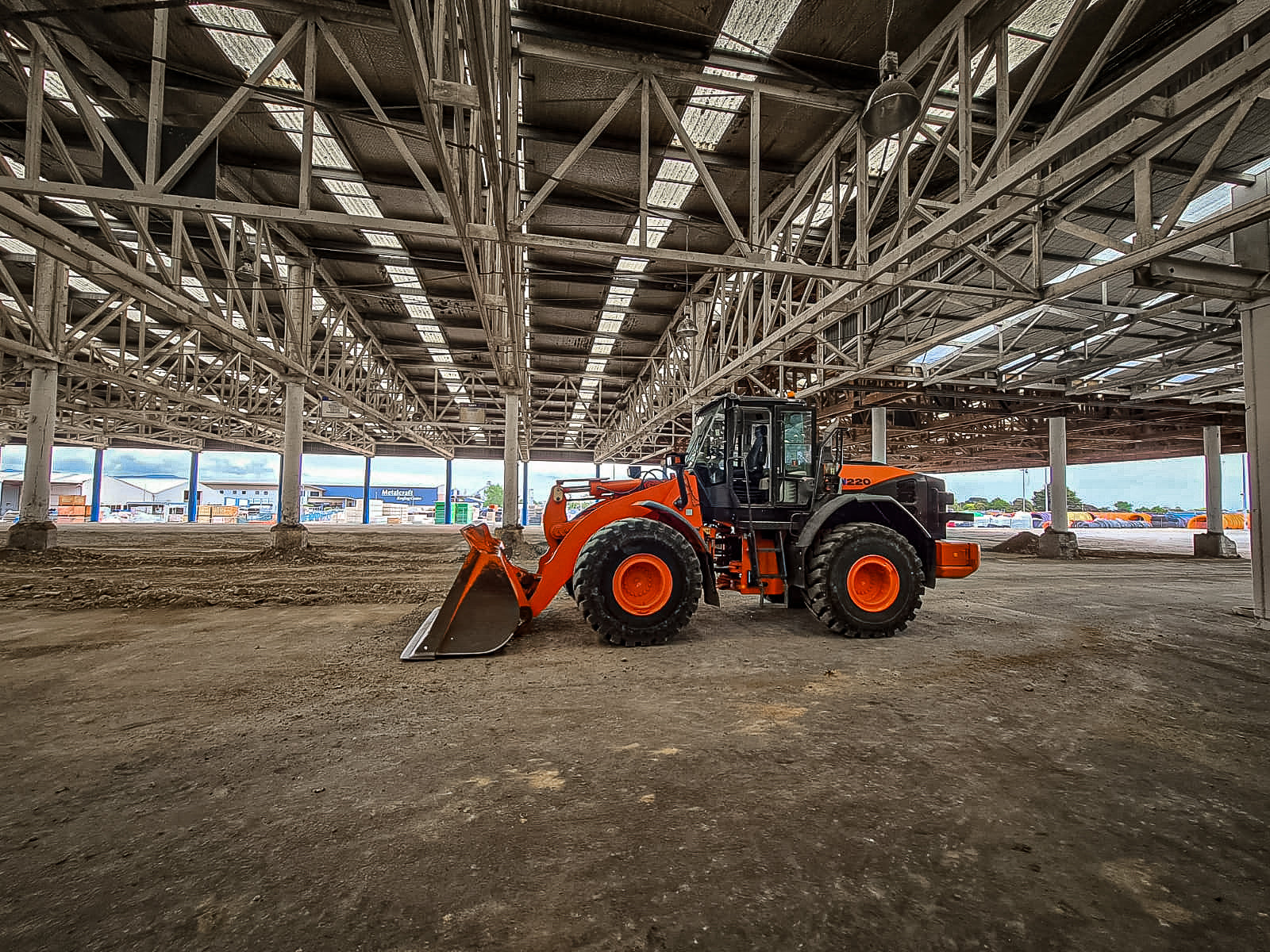 Orange loader in large building
