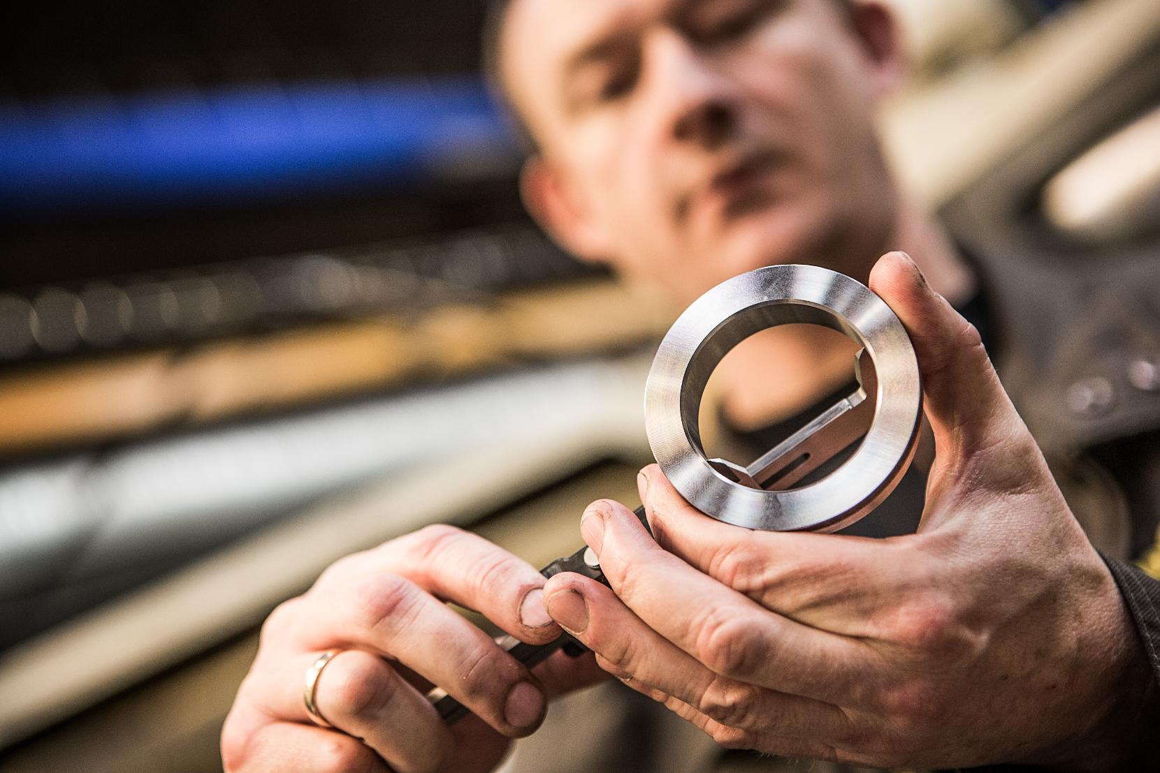 A Hydrema Technician measuring a Hydrema Component